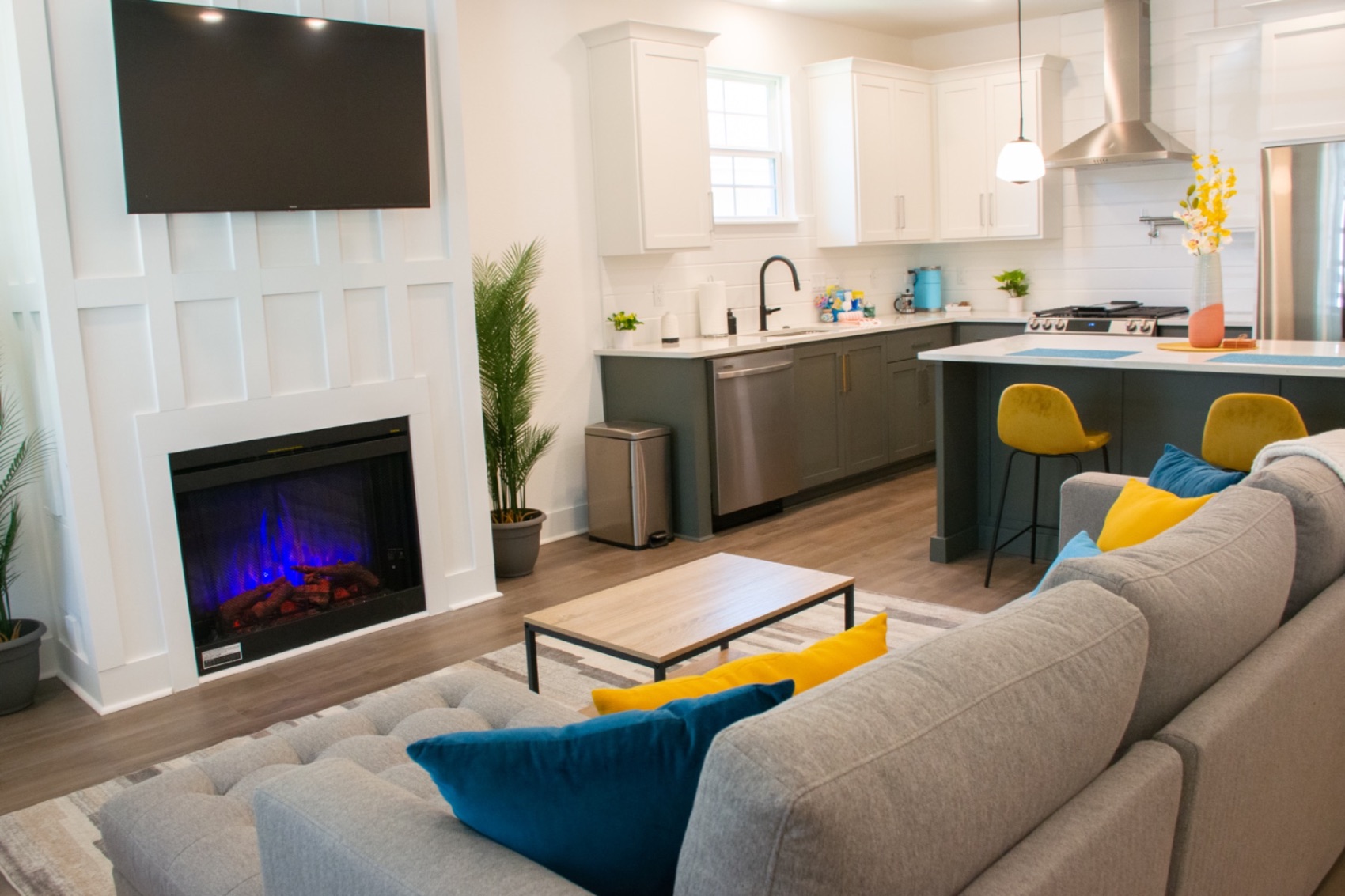 Open-plan living room with fireplace and kitchen