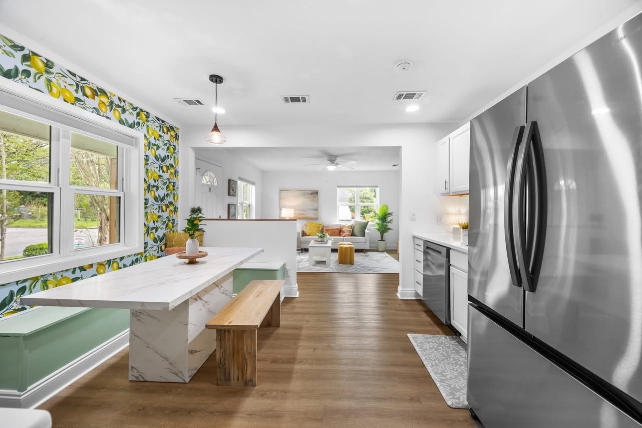 Kitchen with lemon wallpaper open to living room