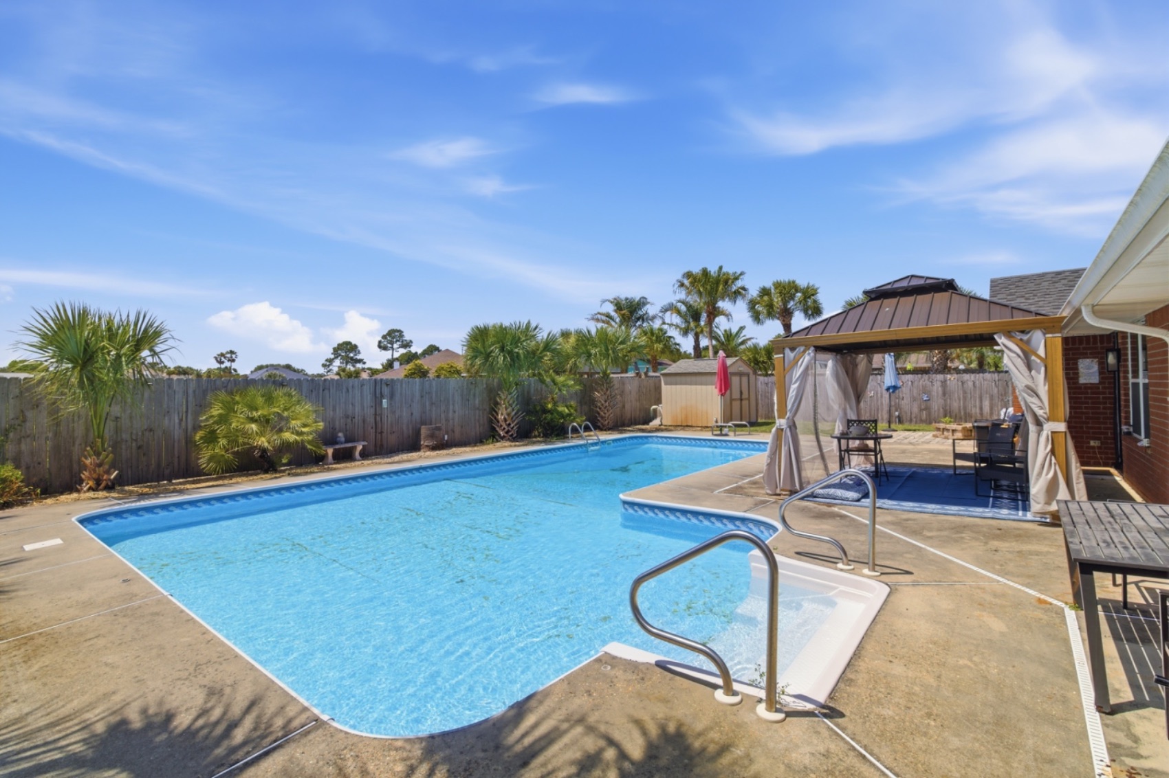 Brick ranch home with palm trees